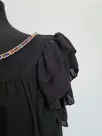 Black blouse with a frill on the sleeves and decorative sequins