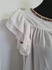 Blouse with a frill on the sleeves and decorative ecru sequins